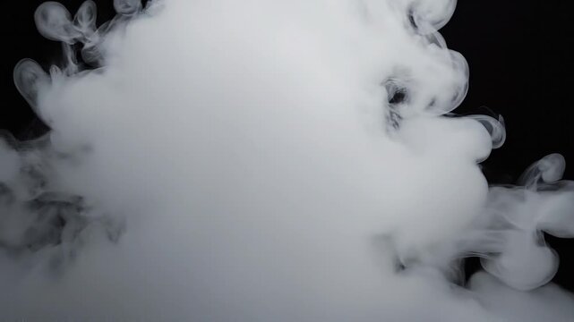 Dense white smoke cloud on black background with soft swirling patterns and mist effect