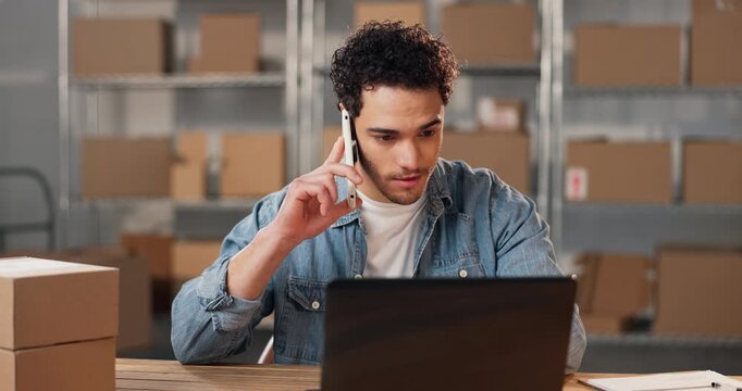 Laptop, phone call and man in office for shipping order, address confirmation or communication. Tech, talking and person with logistics information, delivery schedule and feedback in SME business
