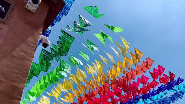 Colorful papel picado banners hanging above street in Huatulco Oaxaca Mexico showcasing traditional Mexican decoration festive atmosphere and cultural celebration
