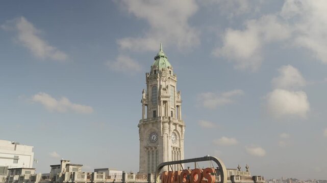 Granite Clock Tower And Green Copper Dome Of Porto City Hall Above The Rooftops