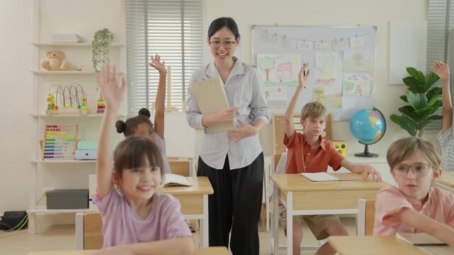 Teacher Helping Diverse Children Learn Bright Elementary Classroom with Raised Hands, Desks, Books, Globe, Colorful Educational Materials, Engaged Students, School Lesson, and Active Learning