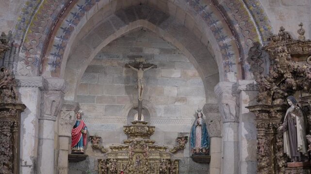 Painted Stone Arch Framing A Crucifix Gilded Altar And Statues In An Old Church