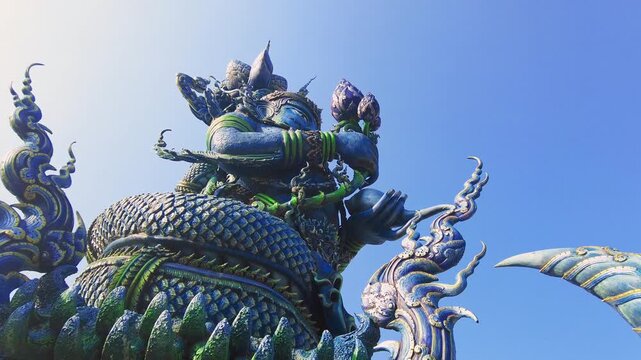 Statue at the entrance of the blue temple Chiang Mai. Zooming in