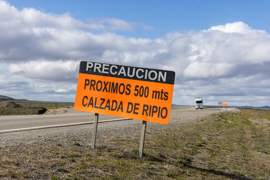 Warning sign along a road on the pampas in southern Argentina that the road becomes unpaved in approximately 500 meters
