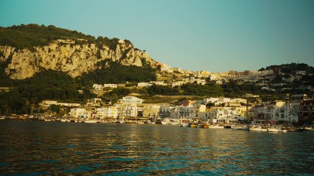 Island of Capri with houses and harbor in the early morning vacation