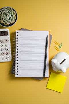 Small business financial planning with calculator and notebook, top view with copy space