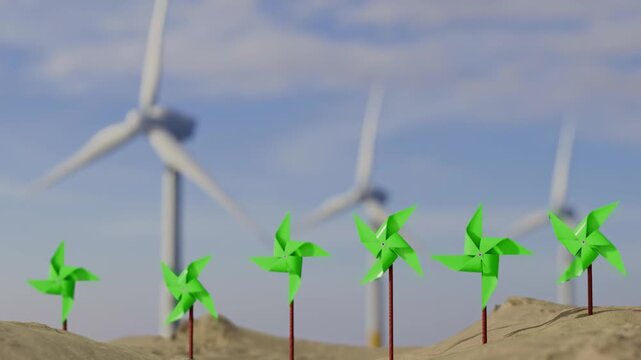 Wind turbines and small pinwheels on sandy terrain under a blue sky