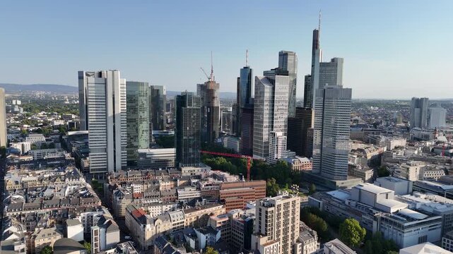 Aerial view of the modern Frankfurt am Main skyline featuring the iconic Westhafen Tower surrounded by glass skyscrapers and urban architecture in Frankfurt am Main, Hessen, Germany.
