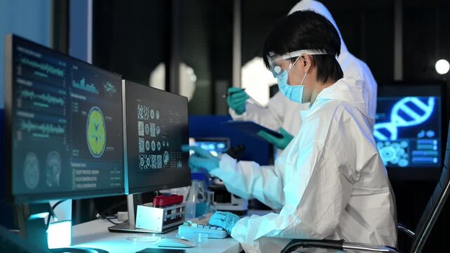 Scientist in protective suit analyzes neurological data and biological samples using a modern microscope in a high tech laboratory.