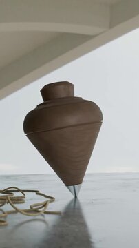 Classic wooden spinning top with string on a reflective surface