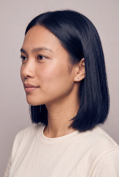Young woman with sleek bob haircut neutral portrait for beauty profile and skincare branding background