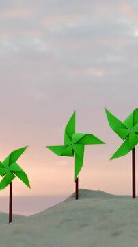 Green pinwheels spinning on sandy dunes at sunset