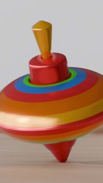 Colorful spinning top toy in motion on a wooden surface