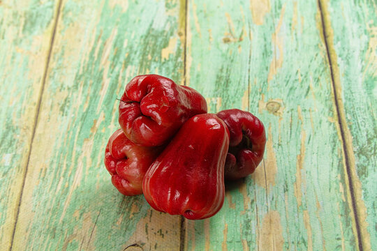 Red rose apples on weathered green wood surface