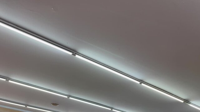 Horizontal view of modern parallel linear LED lights on ceiling