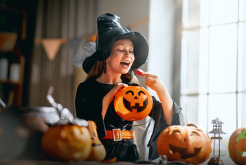 Fototapeta premium Joyful Child Dressed as Witch Celebrating Halloween