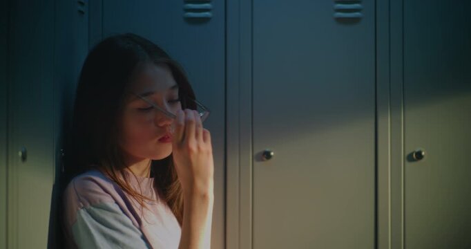 Pensive Female High School Student Sitting by School Lockers During Peaceful Break, Expressing Contemplation, Academic Pressure and Personal Growth. Concept of Mental Health, Student Wellbeing.