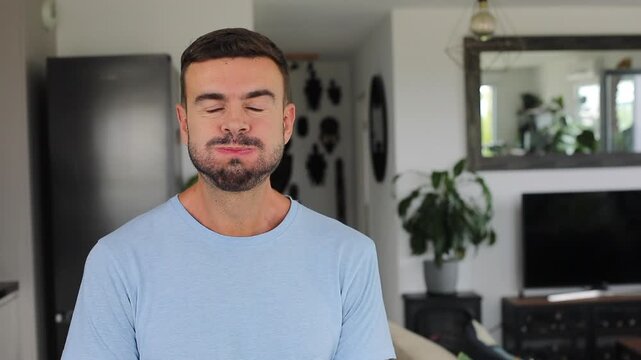 Man taking deep breath and holding it looking at camera