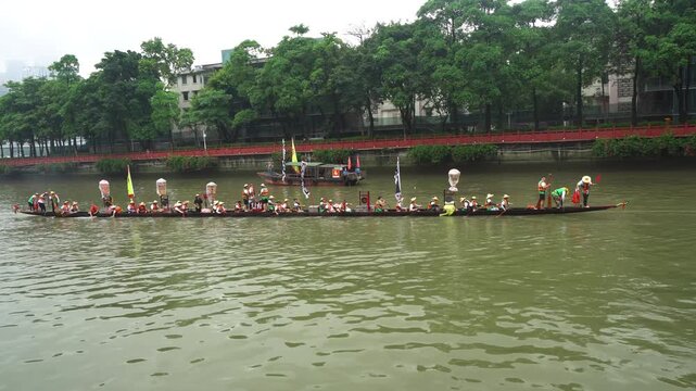 Dragon boat racing team competing on a river during a festival  