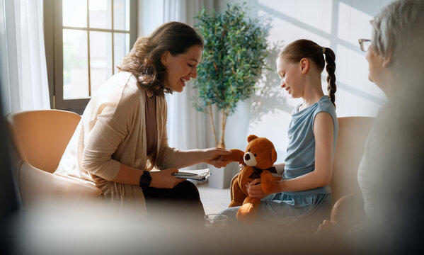 Smiling child during a therapy session with a psychologist and support specialist