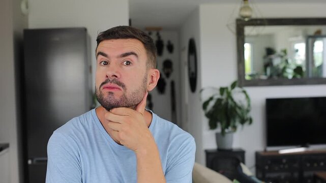 Suspicious man listening carefully before shaking head no in disbelief.