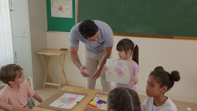 Teacher Guiding Diverse Children in Classroom Art Activity, Supporting Student Artwork, Creative Expression, Learning, Education, and Collaboration at Elementary School