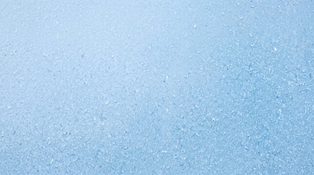 Abstract light blue textured background with subtle sparkling elements.