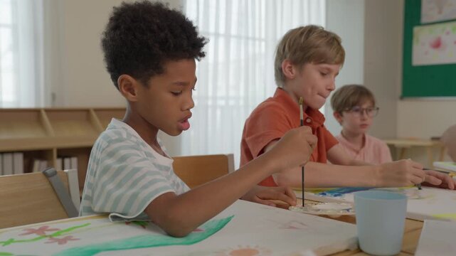 Children Painting Classroom Creative Activity with Colorful Artwork, Art Supply, Teamwork, Learning at Table, Student Drawing, Focused Collaboration and Engaging Art Lesson