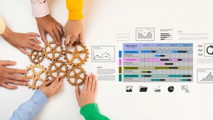 Obraz premium Hands Collaborating on Project Planning with Gears and Data Charts Representing Teamwork, Strategy, and Project Management Tools Gluon.