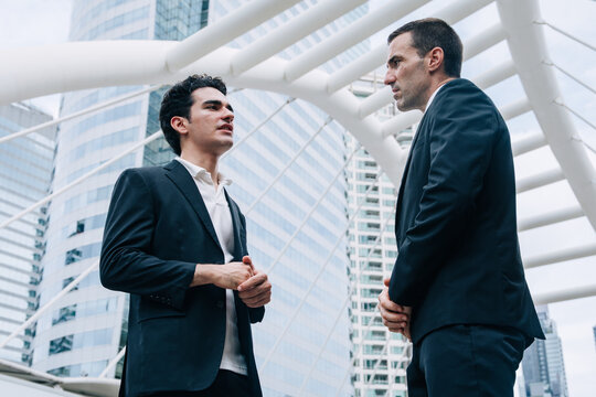 Two Hispanic Latin Businessmen Talking Serious Discussion Corporate Meeting Modern City Outdoor