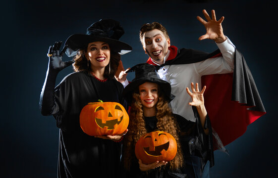Happy Family in Halloween Costumes Celebrating