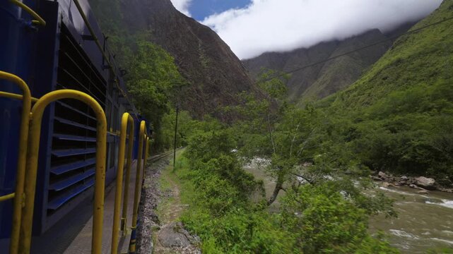 Machu Picchu train Peru Rail Sacred Valley Ollantaytambo in route Aguas Clients Amazon Urubamba river Peru Peruvian Andes mountains range peaks Inca Trail rainy season sunny blue sky clouds forward