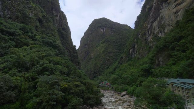 Aguas Calientes town Machu Picchu entrance Amazon Urabumba river dry rainy season afternoon Peru Peruvian Andes Mountains jungle lower highlands Inca trail citadel hotels landscape static shot