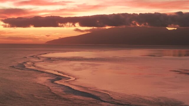 Tahiti golden hour sunset Teahupo'o surf waves crashing shallow coral reef lagoon aerial drone French Polynesia Mount Orohena South Pacific Ocean island Passe Havea harbor view landscape circle right