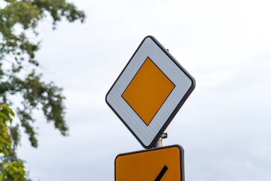 Horizontal street detail photo of priority road traffic sign real life photography