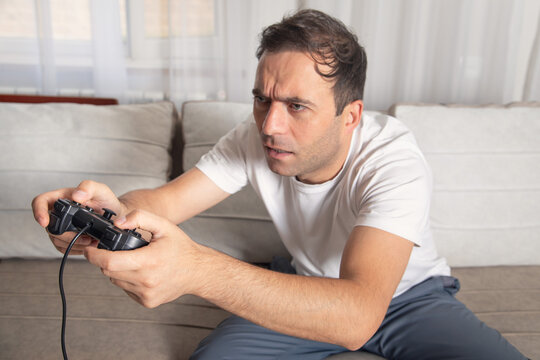 Man playing video game using game controller.