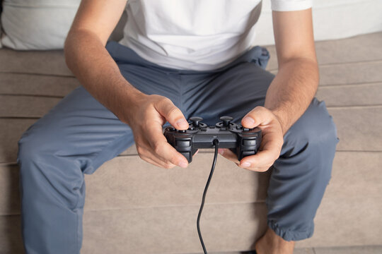 Man playing video game using game controller.