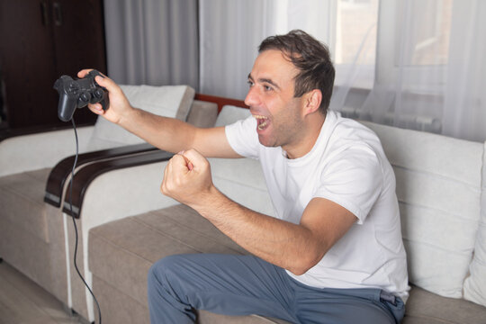 Man playing video game using game controller.