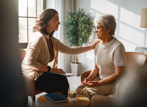 Empathetic Counselor Comforting Senior Woman During Therapy Session