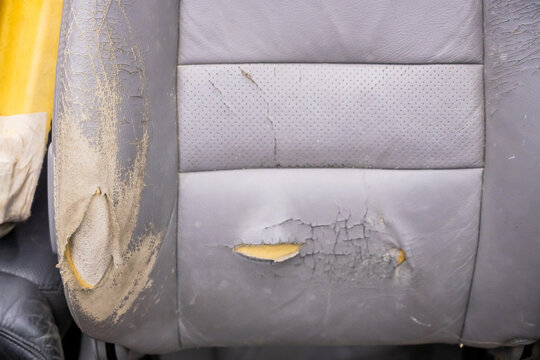 A car seat with worn, torn upholstery. Upholstery replacement.