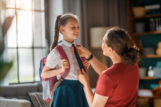 Happy Mother Helping Daughter Get Ready for School Morning Routine