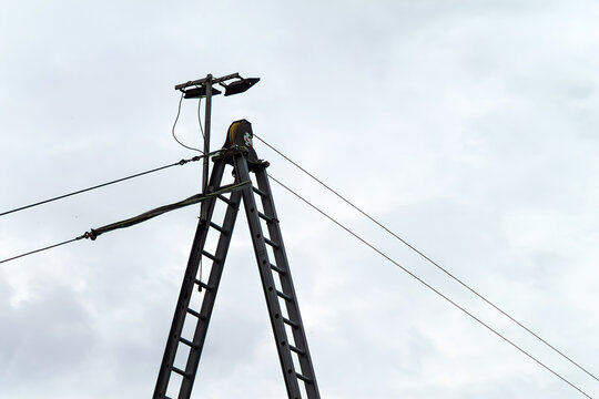 Horizontal urban detail photo of utility pole and wires against cloudy sky real life photography