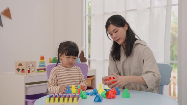 Mother Daughter Child Family Play with Colorful Toy Blocks at Home, Educational Creative Learning Activity Supporting Bonding, Fine Motor Skills, Focused Expressions, and Joyful Family Development