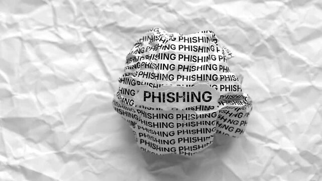Crumpled paper ball with words Phishing on a crumpled white paper background