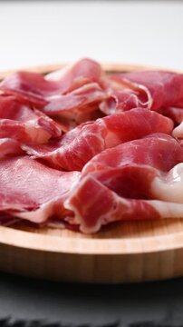 Spanish serrano ham rotating on wooden table
