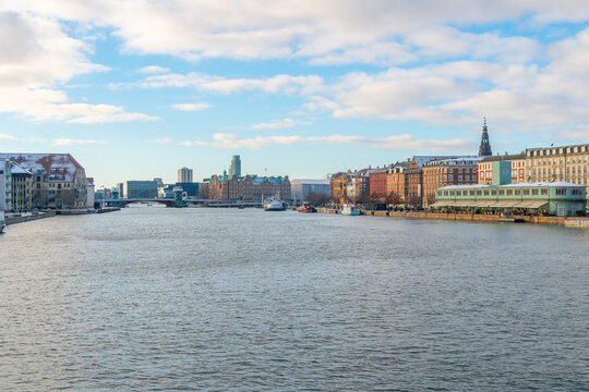 Copenhagen waterfront cityscape with historic buildings and boats on a winter day