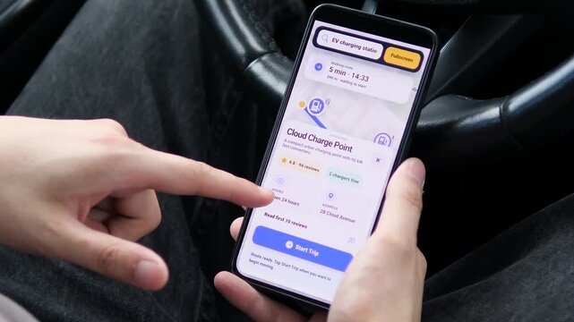 Driver searches nearby EV charging stations on a smartphone, reflecting the rapid rise of electric mobility, smart navigation and cleaner urban transport choices.