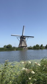 Dutch windmill beside calm canal