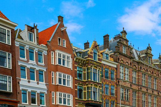Old traditional brick wall houses row in city of Amsterdam