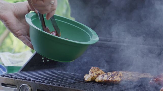 Man with barbeque roast meat sausage outdoor. Grilling and barbecue. BBQ and grill. Preparing beef sausage meat in barbecue. Chef barbecuing sausage. Backyard BBQ. Man cook steak meat
